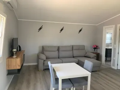a living room with a couch and a table at Casa ILEANA in Sanlúcar de Barrameda