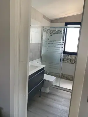 a bathroom with a toilet and a sink and a shower at Casa ILEANA in Sanlúcar de Barrameda