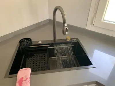 a kitchen sink with a dish drain in it at Casa ILEANA in Sanlúcar de Barrameda