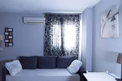 a living room with a couch in front of a window at Pasquín in Cádiz