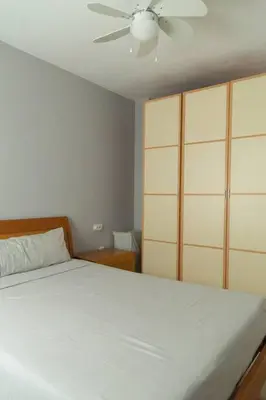a bedroom with a white bed and a ceiling fan at Pasquín in Cádiz