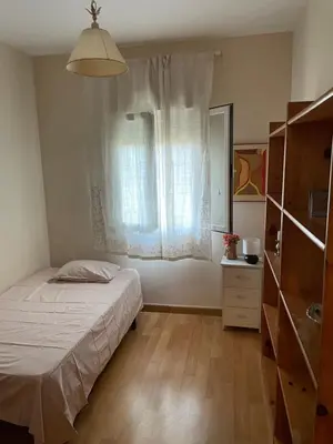 a small bedroom with a bed and a window at Apartamento Vallehermoso in El Puerto de Santa María