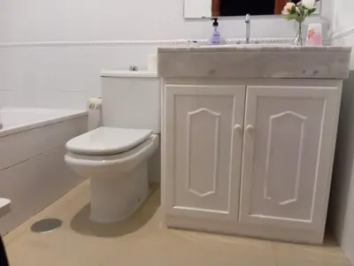 a bathroom with a white toilet and a sink at Apartamento Vallehermoso in El Puerto de Santa María