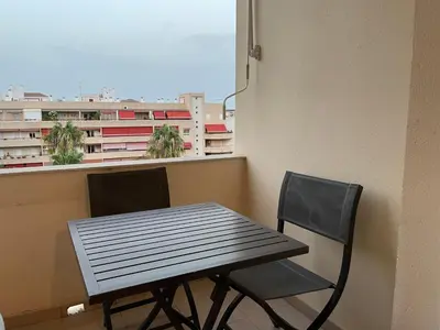 a table and two chairs in front of a window at Apartamento Vallehermoso in El Puerto de Santa María