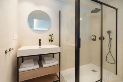 a bathroom with a sink and a shower at Apartamentos Playa Victoria - by Grupo Tribu in Cádiz