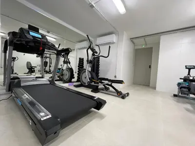 a gym with two exercise bikes and a treadmill at Apartamentos Playa Victoria - by Grupo Tribu in Cádiz