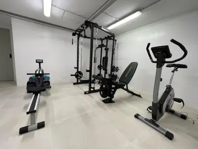 a gym with several exercise equipment in a room at Apartamentos Playa Victoria - by Grupo Tribu in Cádiz