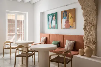 a living room with a couch and two tables and chairs at BYPILLOW Casa Gades in Cádiz