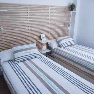 two beds sitting next to each other in a room at Apartamento Luz in Chiclana de la Frontera
