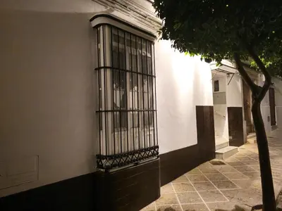 a window with bars on the side of a building at Apartamento Casa Pura in Medina Sidonia