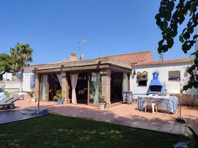 a house with a patio and a table in the yard at EL RETIRO in Sanlúcar de Barrameda