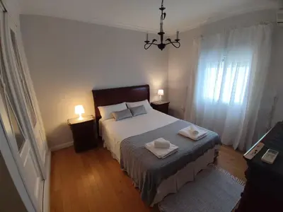 a bedroom with a bed with two towels on it at EL RETIRO in Sanlúcar de Barrameda