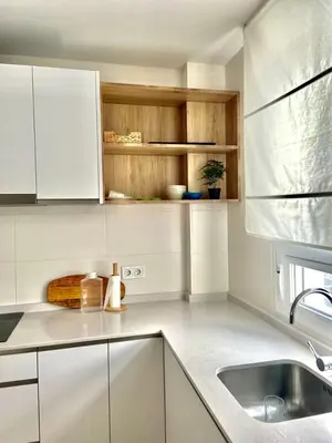 a kitchen with white cabinets and a sink in it at Casita Playa Conil in Conil de la Frontera