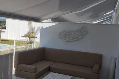 a living room with a couch in a balcony at Casita Playa Conil in Conil de la Frontera