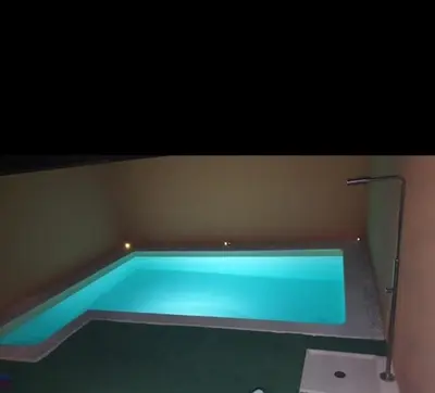 a swimming pool with blue water in a room at Villa Lago Golf, 300m construidos in Jerez de la Frontera