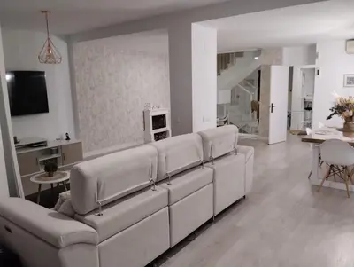 a living room with a white couch and a table at Villa Lago Golf, 300m construidos in Jerez de la Frontera