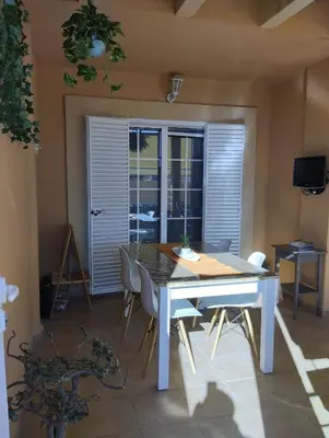 a dining room with a table and chairs and a window at Villa Lago Golf, 300m construidos in Jerez de la Frontera