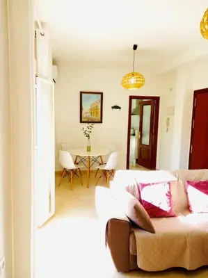 a living room with a couch and a table at Banda playa 82, en pleno corazón de Sanlucar in Sanlúcar de Barrameda