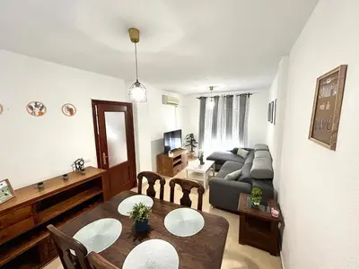 a living room with a couch and a table at Casa SOL y MAR junto a la PLAYA in Sanlúcar de Barrameda