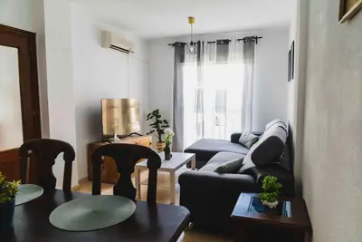 a living room with a couch and a table at Casa SOL y MAR junto a la PLAYA in Sanlúcar de Barrameda