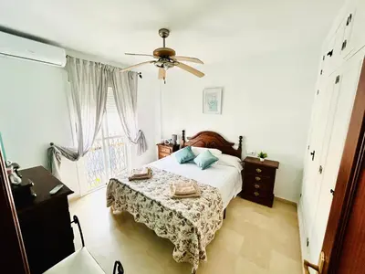 a bedroom with a bed and a ceiling fan at Casa SOL y MAR junto a la PLAYA in Sanlúcar de Barrameda