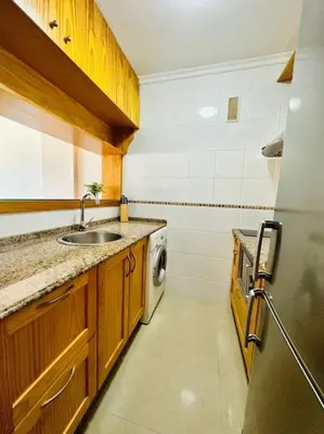 a kitchen with a sink and a washing machine at Apartamento a pie de playa. in Cádiz