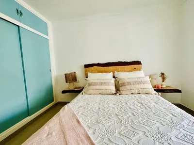 a bedroom with a large bed in a room at Apartamento a pie de playa. in Cádiz