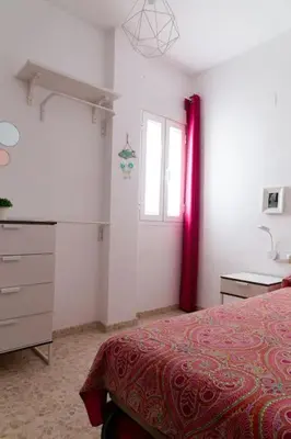 a bedroom with a bed and a dresser and a window at Libertad by Gades Gestión in Cádiz