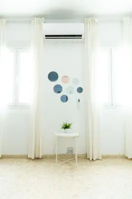 a white room with a table and some windows at Libertad by Gades Gestión in Cádiz