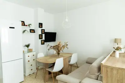 a kitchen and dining room with a table and a couch at Libertad by Gades Gestión in Cádiz