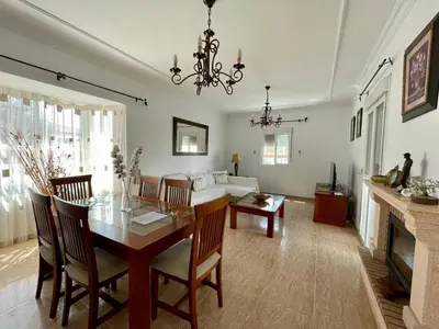 a living room with a table and a couch at Chalet Manku in Chiclana de la Frontera