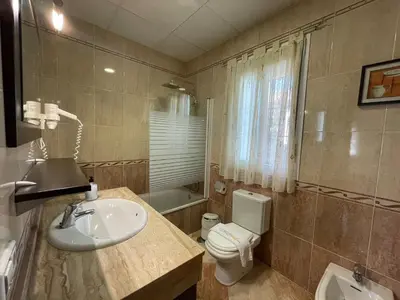 a bathroom with a sink and a toilet at Chalet Manku in Chiclana de la Frontera