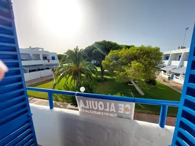 a view of a park from a balcony of a building at La Almadraba in Novo Sancti Petri