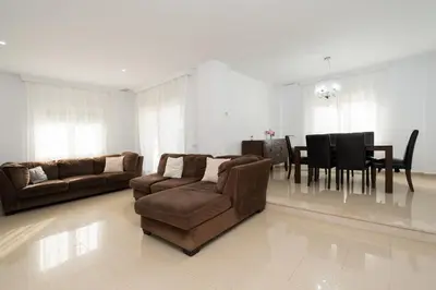 a living room with two couches and a dining room at Apartoyou - Chalet & Pool in El Puerto de Santa María