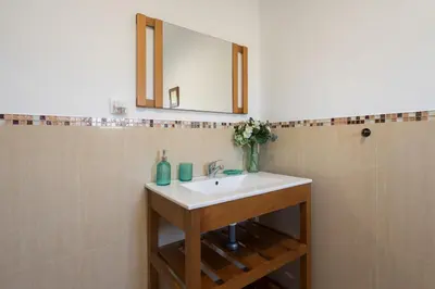 a bathroom with a sink and a mirror at Apartoyou - Chalet & Pool in El Puerto de Santa María