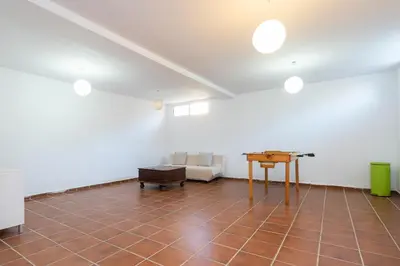 an empty room with a table and chairs at Apartoyou - Chalet & Pool in El Puerto de Santa María