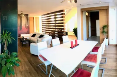 a bed with a tray with a bottle of wine and fruit at Modern Zen Bali in Puerto Real