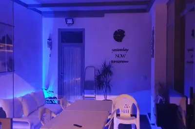 a dining room with a white table and chairs at Modern Zen Bali in Puerto Real