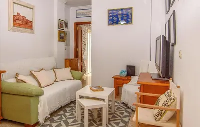 a living room with a couch and a tv at 1 Bedroom Nice Apartment In Chipiona in Chipiona