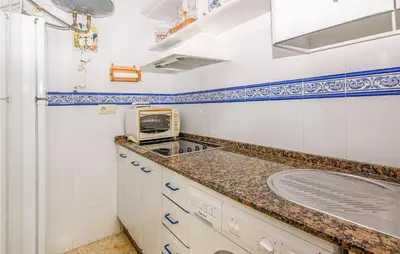 a kitchen with a sink and a microwave at 1 Bedroom Nice Apartment In Chipiona in Chipiona