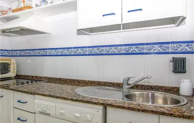 a kitchen with a sink and a counter top at 1 Bedroom Nice Apartment In Chipiona in Chipiona