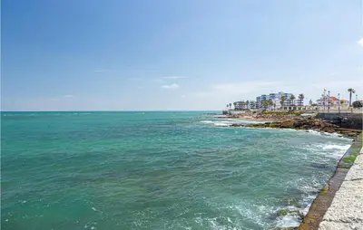 a view of the ocean and a beach with condos at 1 Bedroom Nice Apartment In Chipiona in Chipiona