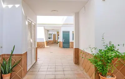 a hallway with potted plants in a building at 1 Bedroom Nice Apartment In Chipiona in Chipiona