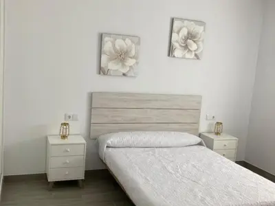 a bedroom with a bed and two night stands at Villa El Lagar in Novo Sancti Petri