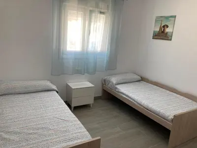 a bedroom with two beds and a window at Villa El Lagar in Novo Sancti Petri