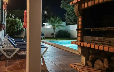 a view of a swimming pool at night at Gorgeous Home In Chiclana De La Fronter in Chiclana de la Frontera