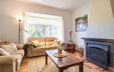 a living room with a couch and a fireplace at Gorgeous Home In Chiclana De La Fronter in Chiclana de la Frontera