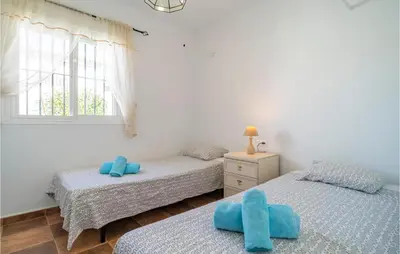 two twin beds in a room with a window at Gorgeous Home In Chiclana De La Fronter in Chiclana de la Frontera