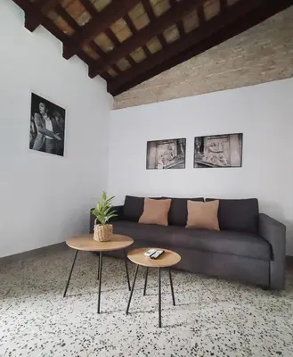 a living room with a couch and two tables at Apartamentos Casa Vicario in Jerez de la Frontera