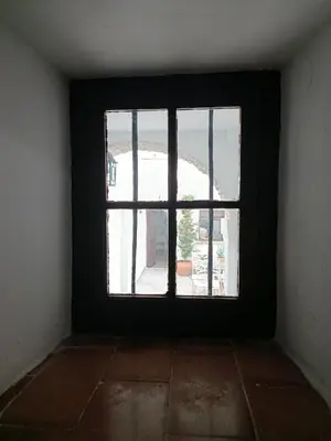 an empty room with a window in a building at Apartamentos Casa Vicario in Jerez de la Frontera